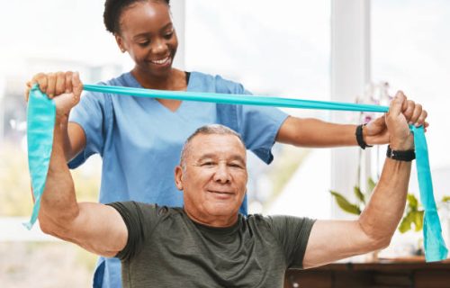 IHSWT Physiotherapy support, stretching band and nurse with senior man for physical therapy, rehabilitation and healthcare help. Black woman chiropractor or physiotherapy doctor consulting elderly patient