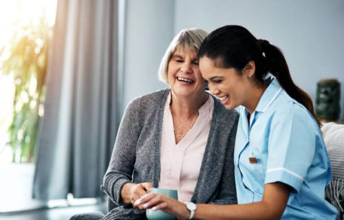 Shot of a young nurse chatting with a senior woman at home Shot of a young nurse chatting with a senior woman at home